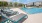 a pool with lounge chairs around it