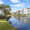 a pond with a fountain in an apartment community