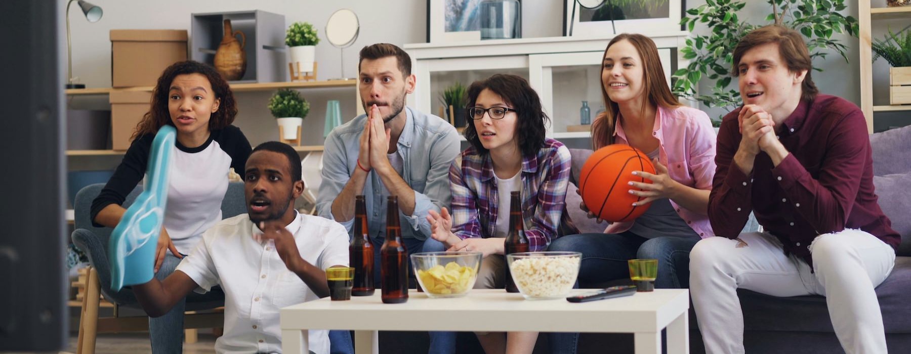 a group of people sitting around a table with food and drinks