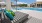 a pool with a lounge chair and umbrella