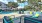 a pool with lounge chairs and umbrellas