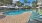 a pool with lounge chairs around it