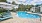 a pool with lounge chairs around it