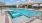 a swimming pool with a building in the background