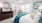 a bedroom with a bed and a fan