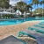 a pool with lounge chairs around it