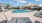 a swimming pool with lounge chairs